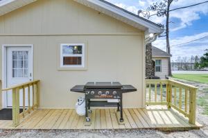 a grill on a deck next to a house at Charming Sylvester Apartment - 17 Mi to Albany! in Sylvester