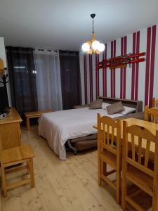 - une chambre avec un lit, une table et des chaises dans l'établissement Apartamento Viman, à Canfranc-Estación