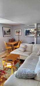 a living room with a white couch and a table at Nature Retreat in the city in Ottawa