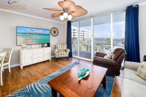 a living room with a couch and a table at Destin West Pelican#408-Resort Corner Lazy River! in Fort Walton Beach