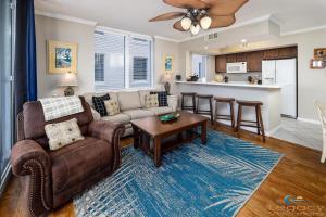 a living room with a couch and a table at Destin West Pelican#408-Resort Corner Lazy River! in Fort Walton Beach