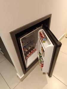 a small refrigerator with its door open in a kitchen at Apartamentos & Flats La Residence Paulista in Sao Paulo