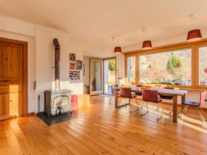 a living room with a table and a wood stove at Holiday Home Vitali by Interhome in Taceno