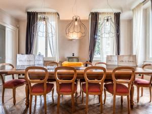 a dining room with a wooden table and chairs at Holiday Home Villa Loreto by Interhome in Costigliole dʼAsti +31 photos