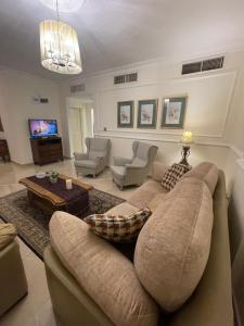 a living room with a couch and a table at A Luxury 2 Bedroom With a perfect location in Sweifiyeh in Amman