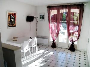 a room with a table and chairs and a window at Apartment Jardins de la mer-10 by Interhome in Saint-Cyr-sur-Mer