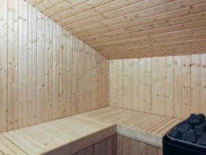 a wooden sauna with a bench in it at Holiday Home Kristiina - 500m from the sea in NW Jutland by Interhome in Saltum