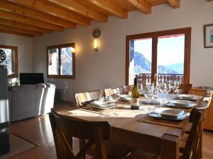 a dining room with a table with wine glasses at Chalet Orchidée by Interhome in Ovronnaz