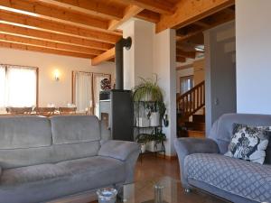 a living room with two couches and a table at Chalet Orchidée by Interhome in Ovronnaz