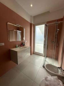 a bathroom with a shower and a sink and a mirror at Tra mare e castello in Barletta +15 photos