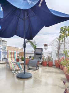 a blue umbrella sitting on top of a patio at La Casona de Palacio Viejo in Arequipa