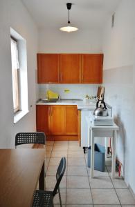 a kitchen with wooden cabinets and a table and chairs at Chalet Paraiso in Sella