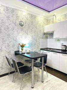 a kitchen with a table and chairs in a room at ЖК Тыныштык in Aktau