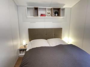 a bedroom with a bed with two white pillows at Holiday Home Tiny Haus Tania by Interhome in Riedenburg