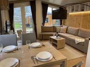 a living room with a table and a couch at Holiday Home Tiny Haus Tania by Interhome in Riedenburg