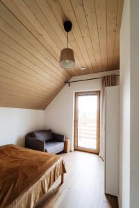 a bedroom with a bed and a couch at Holiday Home Domek pod Szarowym Lasem by Interhome in Wisła +55 photos
