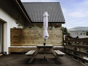 an umbrella sitting on a table on a patio at Holiday Home Domek pod Szarowym Lasem by Interhome in Wisła