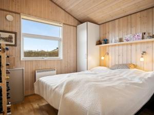 um quarto com uma cama grande e uma janela em Holiday Home Aron - 225m from the sea in SE Jutland by Interhome em Børkop