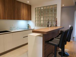 a kitchen with a bar with wine glasses at Apartment Petit Saconnex 28A by Interhome in Geneva