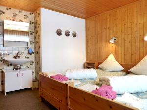 a room with two beds and a sink in it at Chalet Chalet Larix by Interhome in Bürchen