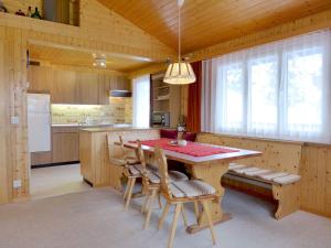 a kitchen with a wooden table and chairs at Chalet Chalet Larix by Interhome in Bürchen