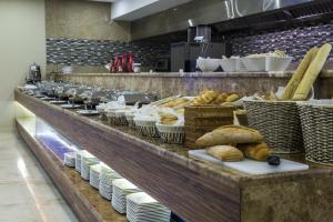 a buffet line of bread and pastries in a restaurant at Radisson Blu Plaza Jeddah in Jeddah