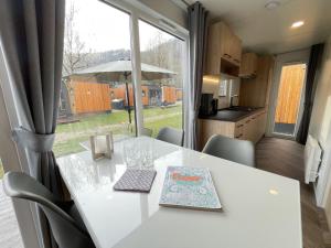 a white table with a book on it in a kitchen at Holiday Home Tiny Haus Xandra by Interhome in Riedenburg