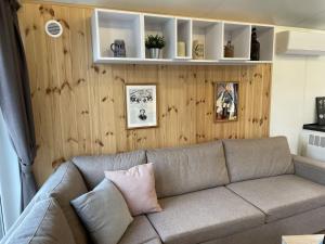 a living room with a couch and wooden walls at Holiday Home Tiny Haus Prinz Ludwig by Interhome in Riedenburg