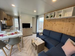 a living room with a blue couch and a table at Holiday Home Tiny Haus Schleusenblick by Interhome in Riedenburg