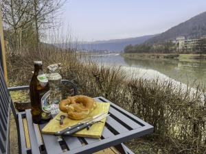 een picknicktafel met een fles bier en een pretzel bij Holiday Home Tiny Haus Schleusenblick by Interhome in Riedenburg