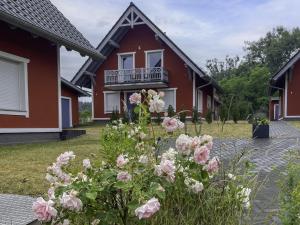 a house with pink flowers in front of it at Urlaub am Plätlinsee Haus Leonore in Wustrow