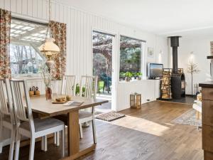 a kitchen and dining room with a table and chairs at Holiday Home Oona - 1-8km from the sea in Sealand by Interhome in Vig