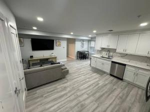 a large living room with a couch and a kitchen at The Elegant Suite - 2BR with Great Amenities in Paterson