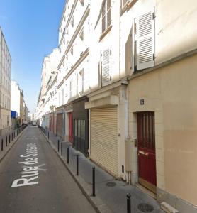 an empty street with a row of buildings at Cocooning & Cosy Apartment in Center Paris 17 in Paris