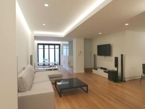 a living room with a white couch and a tv at Apartment Loft Villalonga by Interhome in Valencia