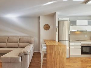 a living room with a couch and a kitchen at Apartment Playa de la Luna by Interhome in Cabopino