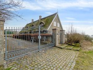 een metalen hek voor een huis bij Holiday Home Herlek - 450m from the sea in Bornholm by Interhome in Åkirkeby