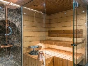 a sauna with a shower and a sink at Holiday Home Levin kuiskaus by Interhome in Sirkka