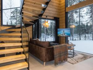 a living room with a couch and stairs at Holiday Home Levin kuiskaus by Interhome in Sirkka