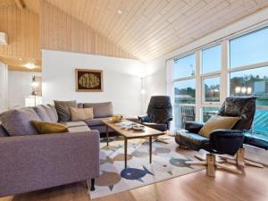 een woonkamer met een bank, stoelen en een tafel bij Holiday Home Ani - 600m from the sea in NW Jutland by Interhome in Torsted