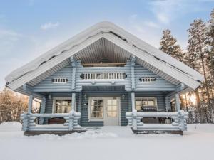 a blue house in the snow at Holiday Home Puljunharju by Interhome in Sattanen