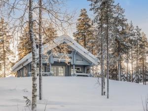 a house in the woods in the snow at Holiday Home Puljunharju by Interhome in Sattanen