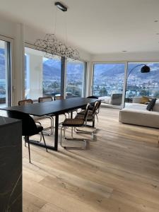 a dining room with a table and chairs with a view at The Hills in Merano