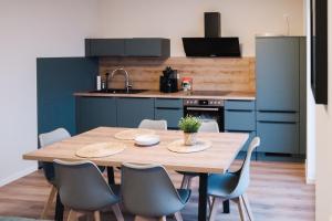 a kitchen with a wooden table and chairs in a room at Fewo Steuerbord in Braunsbedra