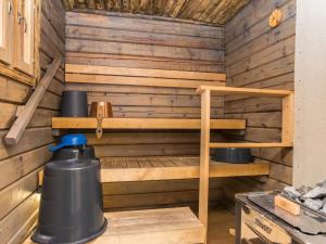 a sauna in a cabin with wooden walls at Holiday Home Villa kuorinka by Interhome 
