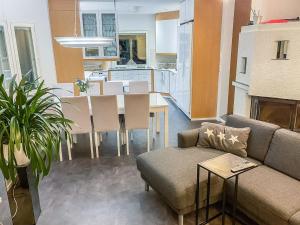 a living room with a couch and a table at Holiday Home Villa jokiranta by Interhome in Eurajoki