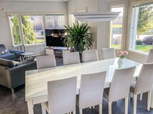 a dining room with a white table and chairs at Holiday Home Villa jokiranta by Interhome in Eurajoki