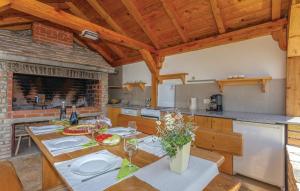 a kitchen with a wooden table with plates and wine glasses at House Soul in Oklaj