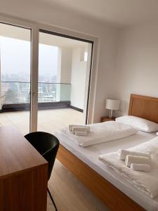 two beds in a room with a balcony at The Hills in Merano