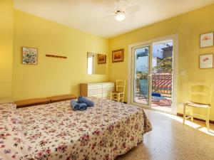 a bedroom with a bed with a teddy bear on it at Holiday Home Can Can Grau by Interhome in Platja  d'Aro